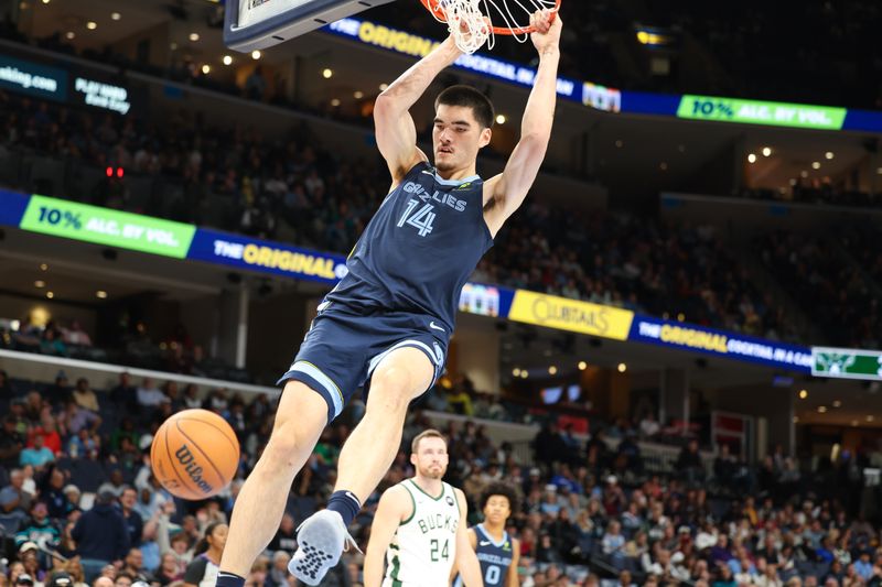 MEMPHIS, TENNESSEE - OCTOBER 31: Zach Edey #14 of the Memphis Grizzlies dunks the ball against the Milwaukee Bucks during the second quarter at FedExForum on October 31, 2024 in Memphis, Tennessee. NOTE TO USER: User expressly acknowledges and agrees that, by downloading and or using this Photograph, user is consenting to the terms and conditions of the Getty Images License Agreement. (Photo by Wes Hale/Getty Images)