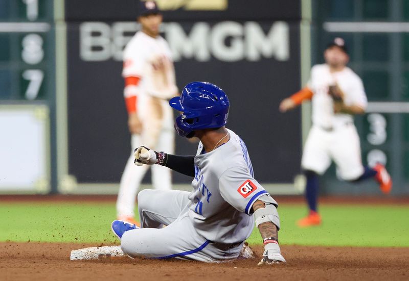May 14, 2025; Houston, Texas, USA; Kansas City Royals third baseman Maikel Garcia (11) slides into second base after hitting a  RBI double against the Houston Astros  in the fifth inning at Daikin Park. Mandatory Credit: Thomas Shea-Imagn Images