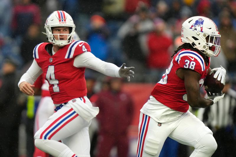 New England Patriots quarterback Bailey Zappe (4) hands off to running back Rhamondre Stevenson (38) during the first half of an NFL football game against the Los Angeles Chargers, Sunday, Dec. 3, 2023, in Foxborough, Mass. (AP Photo/Steven Senne)