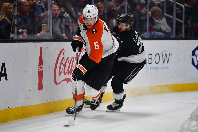 Mar 19, 2026; Los Angeles, California, USA; Philadelphia Flyers defenseman Travis Sanheim (6) moves the puck against Los Angeles Kings center Scott Laughton (21) during the second period at Crypto.com Arena. Mandatory Credit: Gary A. Vasquez-Imagn Images