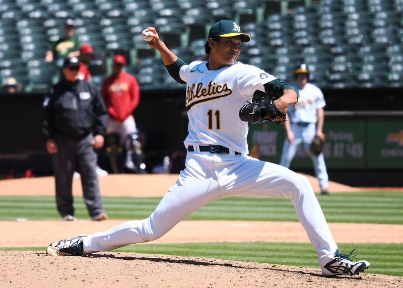 May 17, 2023; Oakland, California, USA; Oakland Athletics relief pitcher Shintaro Fujinami (11) pitches the ball against the Arizona Diamondbacks during the eighth inning at Oakland-Alameda County Coliseum. Mandatory Credit: Kelley L Cox-USA TODAY Sports