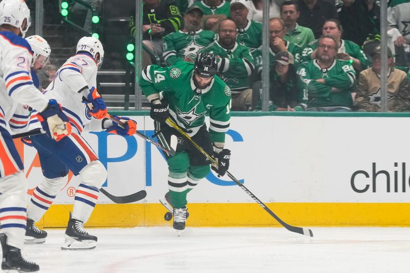 May 31, 2024; Dallas, Texas, USA; Dallas Stars left wing Jamie Benn (14) chases the puck against Edmonton Oilers defenseman Brett Kulak (27) during the second period between the Dallas Stars and the Edmonton Oilers in game five of the Western Conference Final of the 2024 Stanley Cup Playoffs at American Airlines Center. Mandatory Credit: Chris Jones-USA TODAY Sports