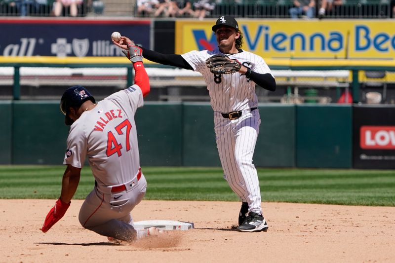 Jun 9, 2024; Chicago, Illinois, USA; Chicago White Sox second base Nicky Lopez (8) forces out Boston Red Sox second baseman Enmanuel Valdez (47) at second base during the fourth inning at Guaranteed Rate Field. Mandatory Credit: David Banks-USA TODAY Sports