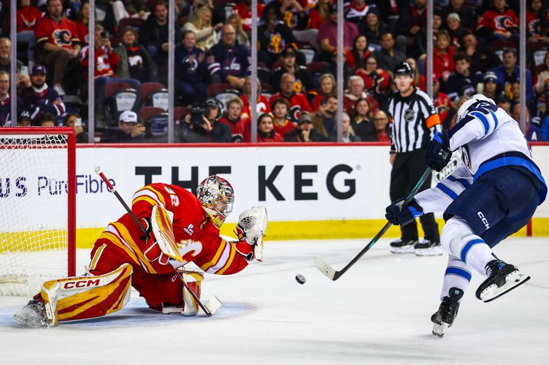 Nov 15, 2025; Calgary, Alberta, CAN; Winnipeg Jets center Gabriel Vilardi (13) scores a goal against Calgary Flames goaltender Dustin Wolf (32) during the shootout period at Scotiabank Saddledome. Mandatory Credit: Sergei Belski-Imagn Images