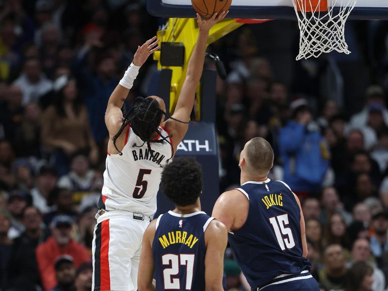 DENVER, COLORADO - FEBRUARY 12: Dalano Banton #5 of the Portland Trail Blazers goes to the basket against Jamal Murray #27 and Nikola Jokic #15 of the Denver Nuggets in the first quarter at Ball Arena on February 12, 2025 in Denver, Colorado. NOTE TO USER: User expressly acknowledges and agrees that, by downloading and or using this photograph, User is consenting to the terms and conditions of the Getty Images License Agreement.   (Photo by Matthew Stockman/Getty Images)