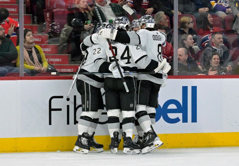 Dec 7, 2023; Montreal, Quebec, CAN; Los Angeles Kings forward Trevor Moore (12) celebrates with teammates including forward Philllip Danault (24) after scoring a goal against the Montreal Canadiens during the third period at the Bell Centre. Mandatory Credit: Eric Bolte-USA TODAY Sports