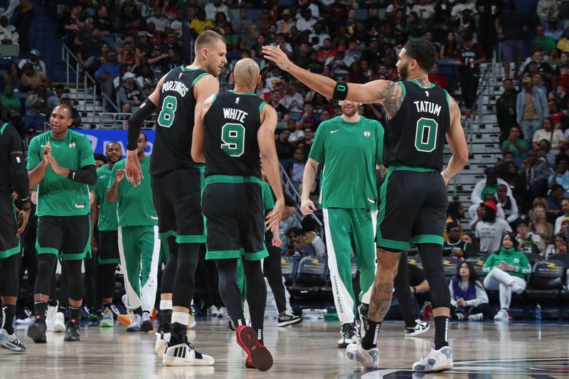 NEW ORLEANS, LA - MARCH 30: Jayson Tatum #0 and Kristaps Porzingis #8 of the Boston Celtics celebrate during the game against the New Orleans Pelicans on March 30, 2024 at the Smoothie King Center in New Orleans, Louisiana. NOTE TO USER: User expressly acknowledges and agrees that, by downloading and or using this Photograph, user is consenting to the terms and conditions of the Getty Images License Agreement. Mandatory Copyright Notice: Copyright 2024 NBAE (Photo by Layne Murdoch Jr./NBAE via Getty Images)