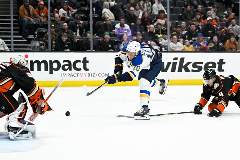 Mar 25, 2023; Anaheim, California, USA; St. Louis Blues center Brayden Schenn (10) shoots a shot in front of Anaheim Ducks defenseman Cam Fowler (4) during the second period at Honda Center. Mandatory Credit: Kelvin Kuo-USA TODAY Sports