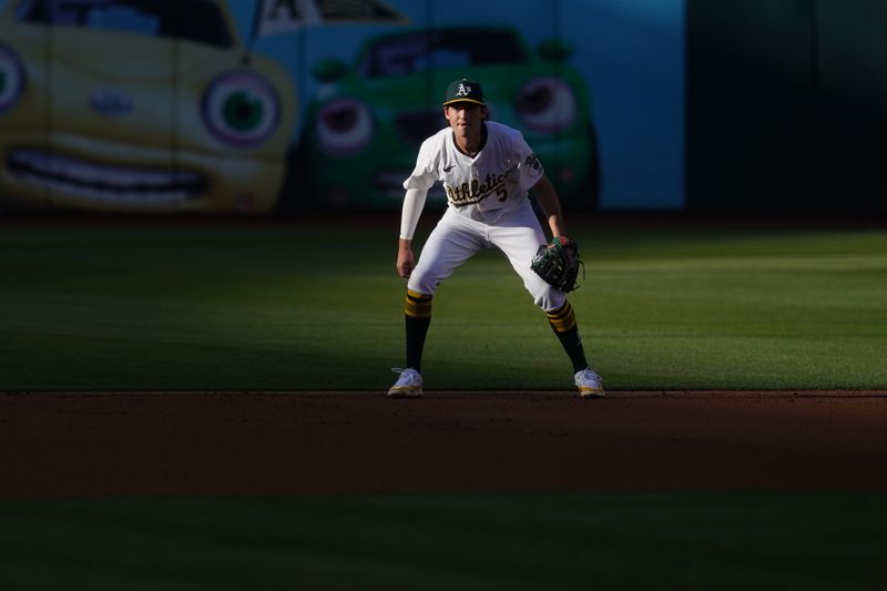 Jul 19, 2024; Oakland, California, USA; Oakland Athletics shortstop Jacob Wilson (5) stands on the field during action against the Los Angeles Angels in the first inning at Oakland-Alameda County Coliseum. Mandatory Credit: Cary Edmondson-USA TODAY Sports