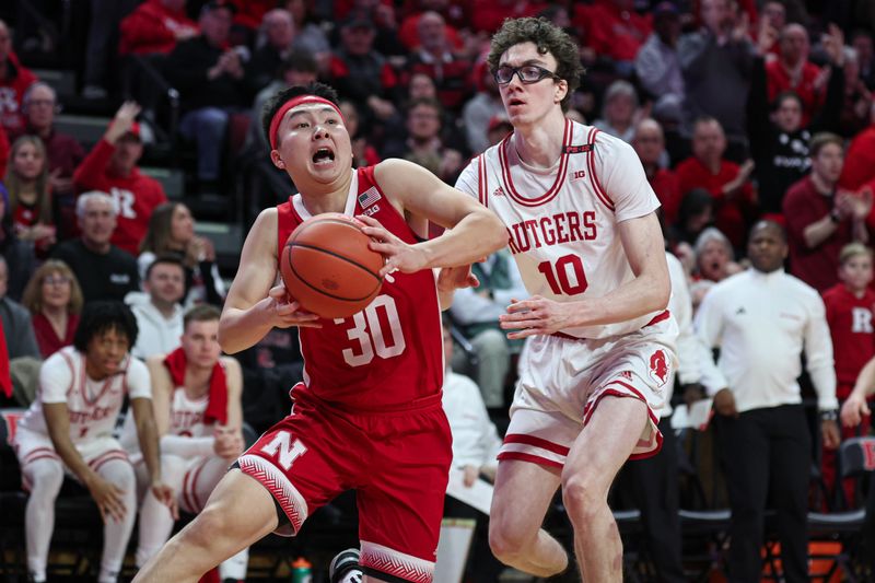 Jan 17, 2024; Piscataway, New Jersey, USA; Nebraska Cornhuskers guard Keisei Tominaga (30) drives to the basket against Rutgers Scarlet Knights guard Gavin Griffiths (10) during the first half at Jersey Mike's Arena. Mandatory Credit: Vincent Carchietta-USA TODAY Sports