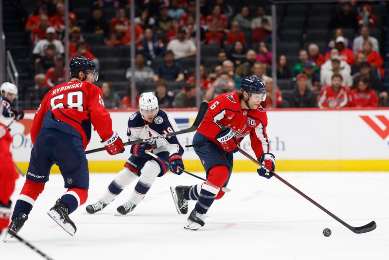 Sep 27, 2024; Washington, District of Columbia, USA; Washington Capitals defenseman Jakob Chychrun (6) skates with the puck past Columbus Blue Jackets center Adam Fantilli (19) in the second period at Capital One Arena. Mandatory Credit: Geoff Burke-Imagn Images