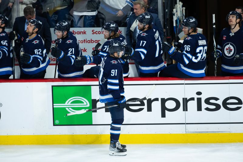 Jan 9, 2024; Winnipeg, Manitoba, CAN; Winnipeg Jets forward Cole Perfetti (91) is congratulated by his teammates on his goal against the Columbus Blue Jackets during the third period at Canada Life Centre. Mandatory Credit: Terrence Lee-USA TODAY Sports