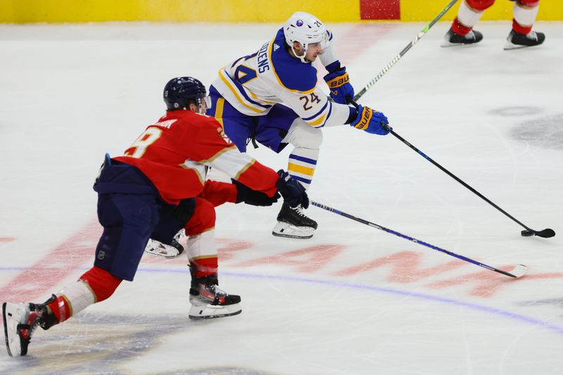 Apr 13, 2024; Sunrise, Florida, USA; Buffalo Sabres center Dylan Cozens (24) moves the puck past Florida Panthers left wing Matthew Tkachuk (19) during the third period at Amerant Bank Arena. Mandatory Credit: Sam Navarro-USA TODAY Sports