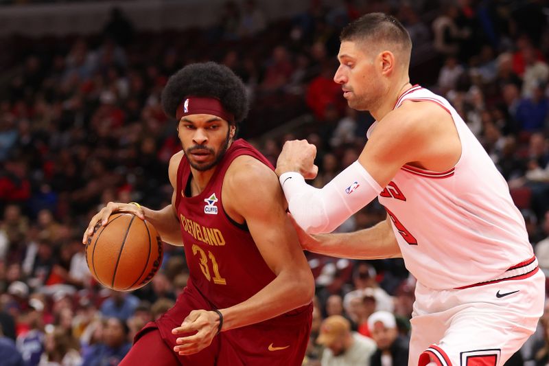 CHICAGO, ILLINOIS - OCTOBER 18: Jarrett Allen #31 of the Cleveland Cavaliers drives to the basket against Nikola Vucevic #9 of the Chicago Bulls during the first half of a preseason game at the United Center on October 18, 2024 in Chicago, Illinois. NOTE TO USER: User expressly acknowledges and agrees that, by downloading and or using this photograph, User is consenting to the terms and conditions of the Getty Images License Agreement.  (Photo by Michael Reaves/Getty Images)