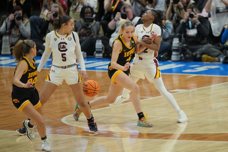 Apr 7, 2024; Cleveland, OH, USA; South Carolina Gamecocks guard MiLaysia Fulwiley (12) attempts to steal the ball from Iowa Hawkeyes guard Kylie Feuerbach (4) in the finals of the Final Four of the womens 2024 NCAA Tournament at Rocket Mortgage FieldHouse. Mandatory Credit: Aaron Doster-USA TODAY Sports
