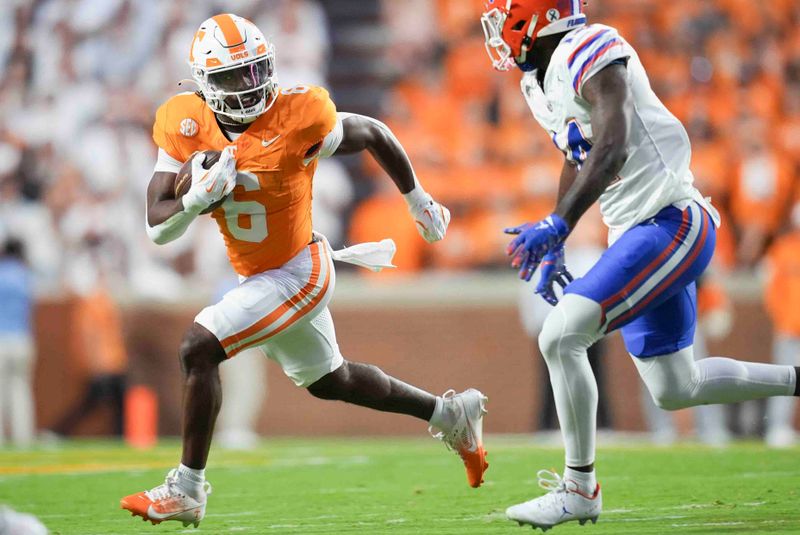 Oct 12, 2024; Knoxville, Tennessee, USA; Tennessee Volunteers running back Dylan Sampson (6) runs the ball against Florida Gators defensive back Jordan Castell (14) at Neyland Stadium. Mandatory Credit: Brianna Paciorka/USA TODAY Network via Imagn Images