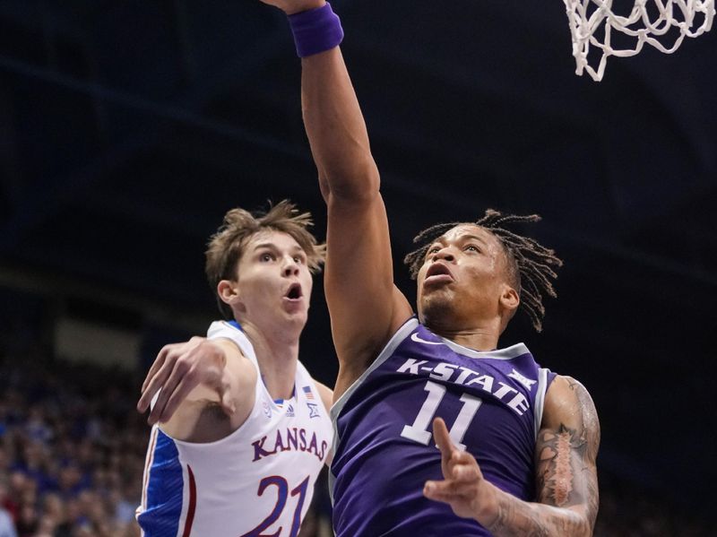 Jan 31, 2023; Lawrence, Kansas, USA; Kansas State Wildcats forward Keyontae Johnson (11) shoots against Kansas Jayhawks forward Zach Clemence (21) during the first half at Allen Fieldhouse. Mandatory Credit: Jay Biggerstaff-USA TODAY Sports