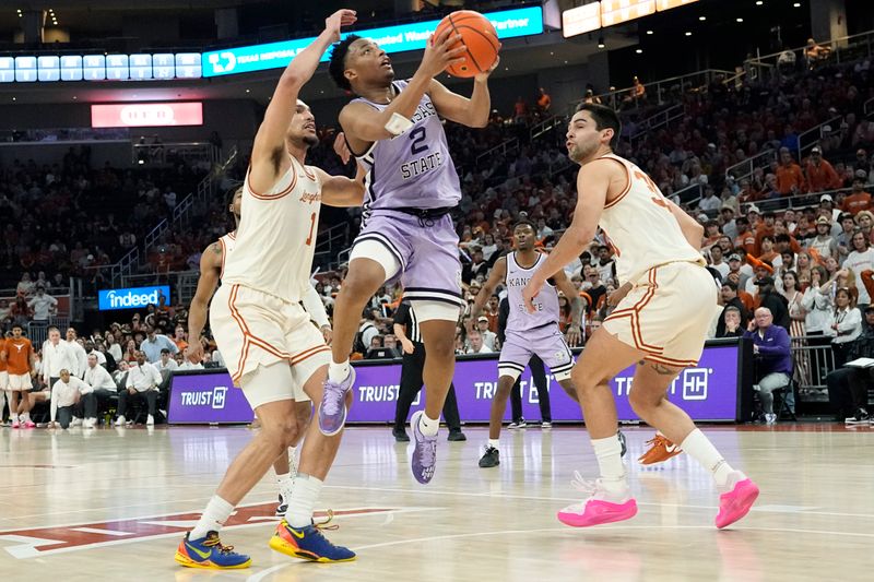 Feb 19, 2024; Austin, Texas, USA; Kansas State Wildcats guard Tylor Perry (2) drives to the basket while defended by Texas Longhorns forwards Dylan Disu (1) and Brock Cunningham (30) during the second half at Moody Center. Mandatory Credit: Scott Wachter-USA TODAY Sports