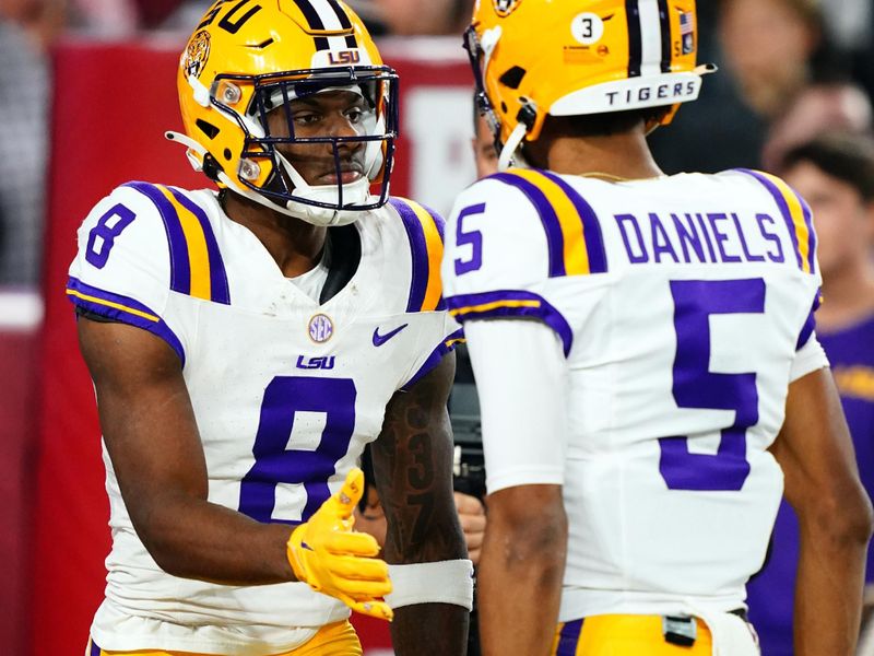 Nov 4, 2023; Tuscaloosa, Alabama, USA; LSU Tigers wide receiver Malik Nabers (8) celebrates his 46 yard touchdown with quarterback Jayden Daniels (5) against the Alabama Crimson Tide during the first quarter at Bryant-Denny Stadium. Mandatory Credit: John David Mercer-USA TODAY Sports