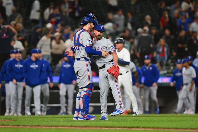 Sep 12, 2024; Seattle, Washington, USA; Texas Rangers catcher Jonah Heim (28) and relief pitcher Kirby Yates (39) celebrate defeating the Seattle Mariners at T-Mobile Park. Mandatory Credit: Steven Bisig-Imagn Images