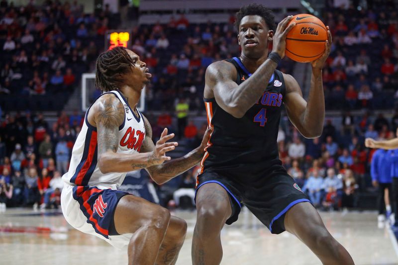 Jan 10, 2024; Oxford, Mississippi, USA; Florida Gators forward Tyrese Samuel (4) handles the ball as Mississippi Rebels guard Allen Flanigan (7) defends during the first half at The Sandy and John Black Pavilion at Ole Miss. Mandatory Credit: Petre Thomas-USA TODAY Sports