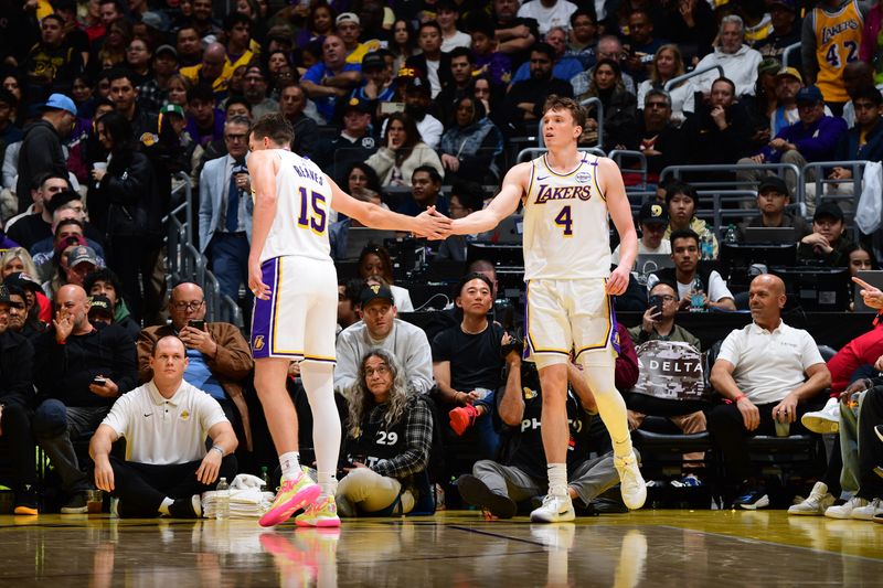 LOS ANGELES, CA - NOVEMBER 23: Austin Reaves #15 high fives Dalton Knecht #4 of the Los Angeles Lakers during the game against the Denver Nuggets on November 23, 2024 at Crypto.Com Arena in Los Angeles, California. NOTE TO USER: User expressly acknowledges and agrees that, by downloading and/or using this Photograph, user is consenting to the terms and conditions of the Getty Images License Agreement. Mandatory Copyright Notice: Copyright 2024 NBAE (Photo by Adam Pantozzi/NBAE via Getty Images)