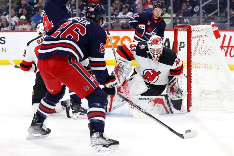 Apr 2, 2023; Winnipeg, Manitoba, CAN; Winnipeg Jets right wing Blake Wheeler (26) gets set to shoot on New Jersey Devils goaltender Vitek Vanecek (41) in the second period at Canada Life Centre. Mandatory Credit: James Carey Lauder-USA TODAY Sports