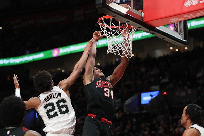 PORTLAND, OREGON - DECEMBER 29: Jabari Walker #34 of the Portland Trail Blazers drives to the basket as Dominick Barlow #26 of the San Antonio Spurs defends during the third quarter at Moda Center on December 29, 2023 in Portland, Oregon. NOTE TO USER: User expressly acknowledges and agrees that, by downloading and or using this photograph, User is consenting to the terms and conditions of the Getty Images License Agreement.? (Photo by Amanda Loman/Getty Images)