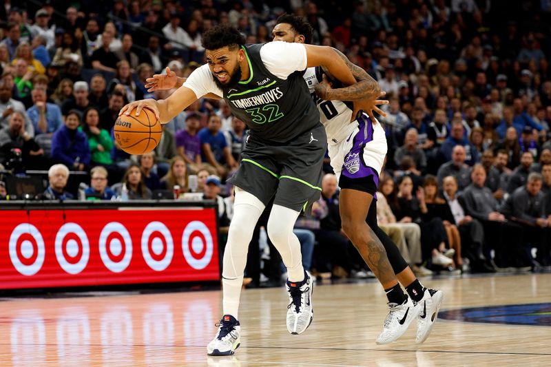 MINNEAPOLIS, MINNESOTA - MARCH 01: Karl-Anthony Towns #32 of the Minnesota Timberwolves draws a foul against Malik Monk #0 of the Sacramento Kings during overtime at Target Center on March 01, 2024 in Minneapolis, Minnesota. The Kings defeated the Timberwolves 124-120 in overtime. NOTE TO USER: User expressly acknowledges and agrees that, by downloading and or using this photograph, User is consenting to the terms and conditions of the Getty Images License Agreement. (Photo by David Berding/Getty Images)