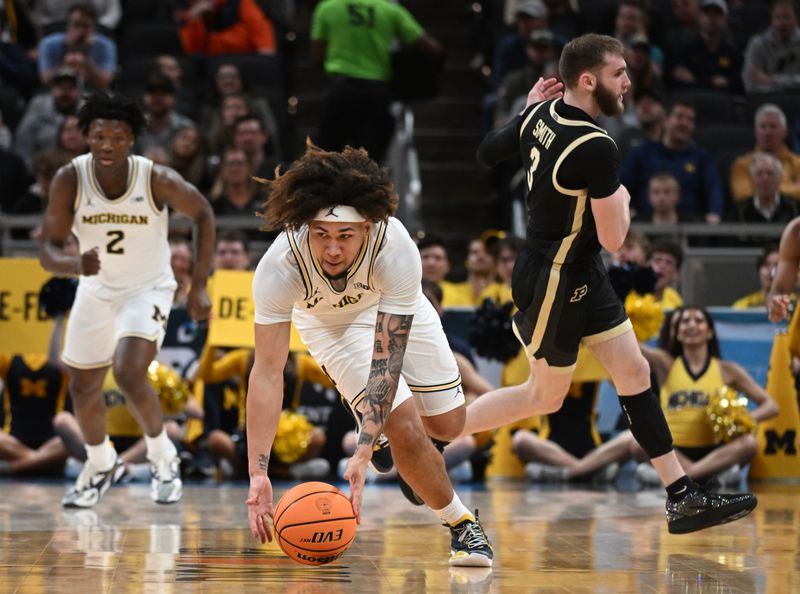 Mar 14, 2025; Indianapolis, IN, USA; Michigan Wolverines guard Tre Donaldson (3) picks up a loose ball in front of Purdue Boilermakers guard Braden Smith (3) during the first half at Gainbridge Fieldhouse. Mandatory Credit: Robert Goddin-Imagn Images