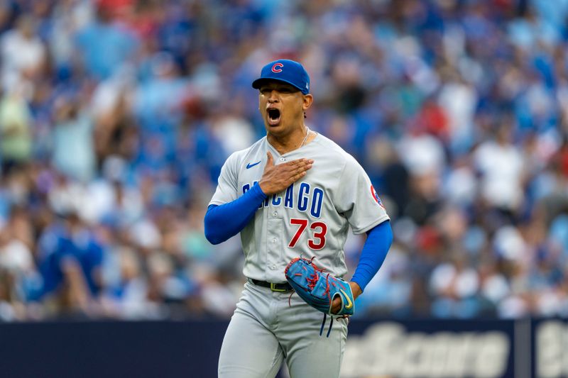 Aug 12, 2023; Toronto, Ontario, CAN; Chicago Cubs relief pitcher Adbert Alzolay (73) celebrates after defeating the Toronto Blue Jays during the ninth inning at Rogers Centre. Mandatory Credit: Kevin Sousa-USA TODAY Sports