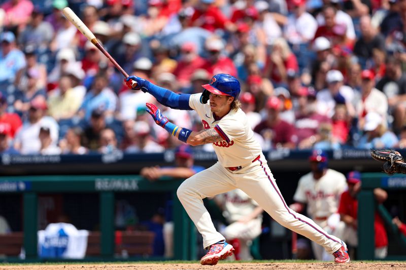 Jul 31, 2024; Philadelphia, Pennsylvania, USA;  Philadelphia Phillies second base Bryson Stott (5) hits a single during the seventh inning against the New York Yankees at Citizens Bank Park. Mandatory Credit: Bill Streicher-USA TODAY Sports