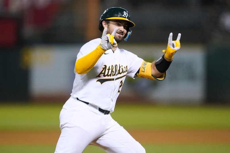 Jul 19, 2024; Oakland, California, USA; Oakland Athletics catcher Shea Laneliers (23) celebrates after hitting a two-run home run against the Los Angeles Angels in the sixth inning at Oakland-Alameda County Coliseum. Mandatory Credit: Cary Edmondson-USA TODAY Sports