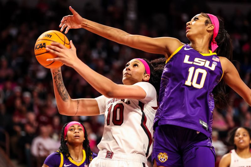 Feb 12, 2023; Columbia, South Carolina, USA; South Carolina Gamecocks center Kamilla Cardoso (10) drives past LSU Lady Tigers forward Angel Reese (10) in the first half at Colonial Life Arena. Mandatory Credit: Jeff Blake-USA TODAY Sports