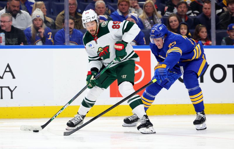 Nov 27, 2024; Buffalo, New York, USA;  Buffalo Sabres center Tage Thompson (72) tries to block a pass by Minnesota Wild center Frederick Gaudreau (89) during the third period at KeyBank Center. Mandatory Credit: Timothy T. Ludwig-Imagn Images