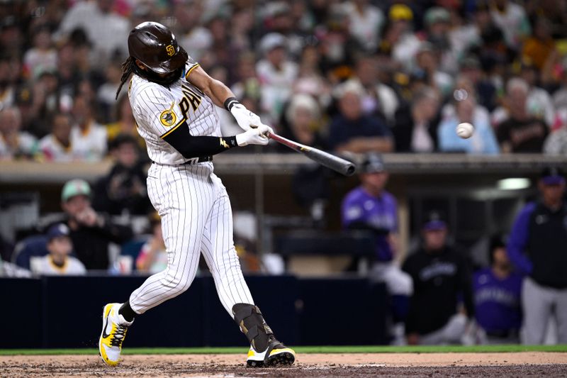 Sep 18, 2023; San Diego, California, USA; San Diego Padres right fielder Fernando Tatis Jr. (23) hits a single against the Colorado Rockies during the fourth inning at Petco Park. Mandatory Credit: Orlando Ramirez-USA TODAY Sports