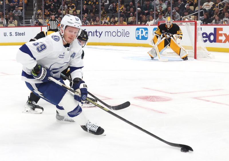 Jan 13, 2026; Pittsburgh, Pennsylvania, USA;  Tampa Bay Lightning center Jake Guentzel (59) handles the puck against Pittsburgh Penguins defenseman Ryan Shea (5) during the second period at PPG Paints Arena. Mandatory Credit: Charles LeClaire-Imagn Images