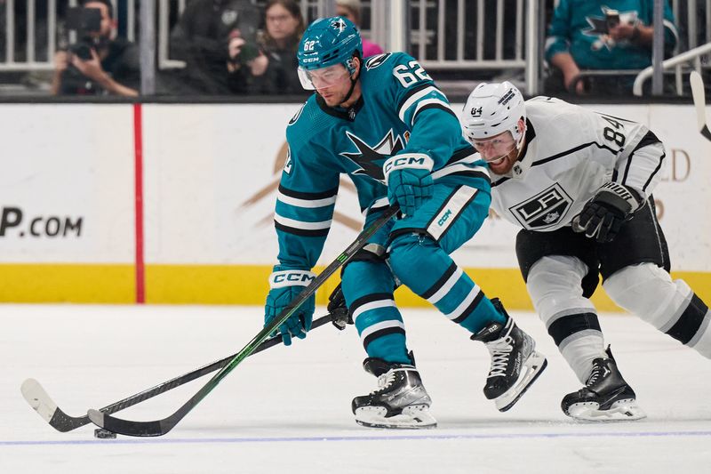 Apr 4, 2024; San Jose, California, USA; Los Angeles Kings defenseman Vladislav Gavrikov (84) extends for the puck against San Jose Sharks right wing Kevin Labanc (62) during the third period at SAP Center at San Jose. Mandatory Credit: Robert Edwards-USA TODAY Sports