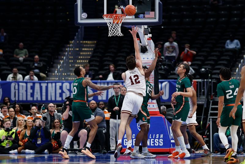 Mar 12, 2024; Washington, D.C., USA; Boston College Eagles forward Quinten Post (12) shoots the ball as Miami (Fl) Hurricanes forward Norchad Omier (15) defends in the first half at Capital One Arena. Mandatory Credit: Geoff Burke-USA TODAY Sports