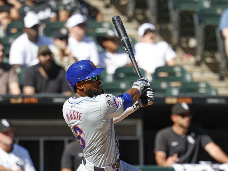 Sep 1, 2024; Chicago, Illinois, USA; New York Mets outfielder Starling Marte (6) hits an RBI-double against the Chicago White Sox during the ninth inning at Guaranteed Rate Field. Mandatory Credit: Kamil Krzaczynski-USA TODAY Sports