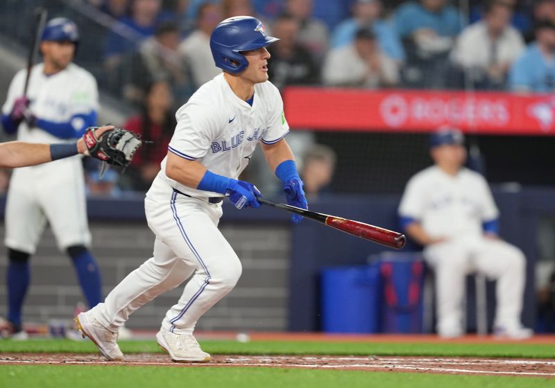 Apr 9, 2024; Toronto, Ontario, CAN; Toronto Blue Jays outfielder Daulton Varsho (25) hits a single against the Seattle Mariners during the third inning at Rogers Centre. Mandatory Credit: Nick Turchiaro-USA TODAY Sports