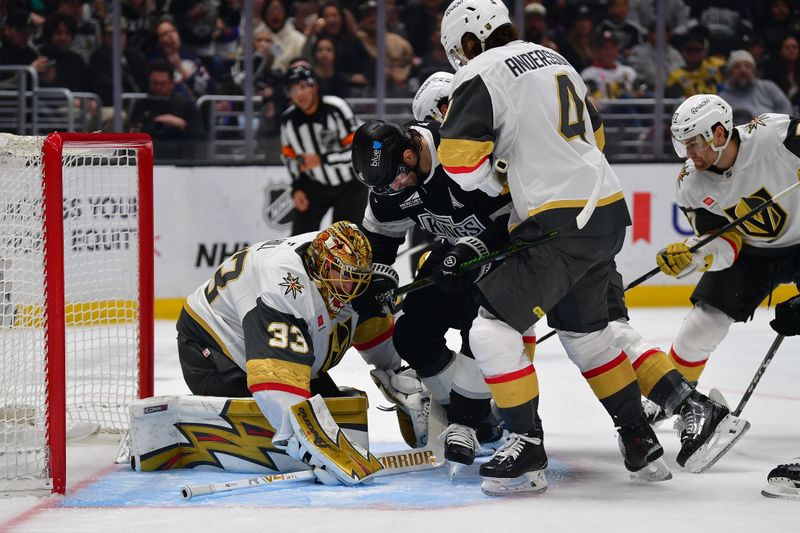Feb 25, 2026; Los Angeles, California, USA; Los Angeles Kings right wing Adrian Kempe (9) moves in for the rebound against Vegas Golden Knights goaltender Adin Hill (33) and defenseman Rasmus Andersson (4) during the second period at Crypto.com Arena. Mandatory Credit: Gary A. Vasquez-Imagn Images