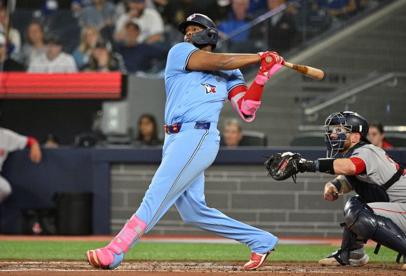 Sep 24, 2024; Toronto, Ontario, CAN; Toronto Blue Jays designated hitter Vladimir Guerrero Jr. (27) hits a two run RBI double against the Boston Red Sox in the third inning at Rogers Centre. Mandatory Credit: Dan Hamilton-Imagn Images