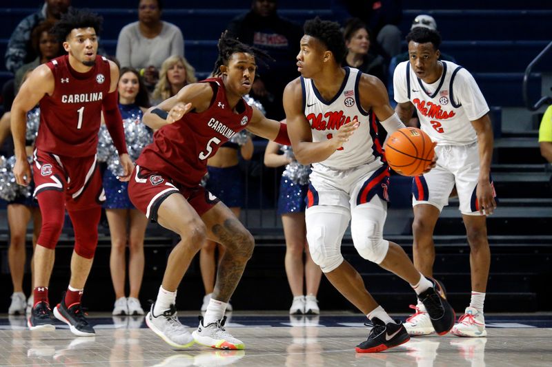 Feb 11, 2023; Oxford, Mississippi, USA; Mississippi Rebels guard Matthew Murrell (11) dribbles as South Carolina Gamecocks guard Meechie Johnson (5) defends during the first half at The Sandy and John Black Pavilion at Ole Miss. Mandatory Credit: Petre Thomas-USA TODAY Sports