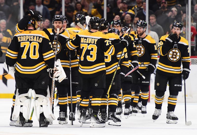 Nov 7, 2024; Boston, Massachusetts, USA;  The Boston Bruins celebrate after defeating the Calgary Flames in overtime at TD Garden. Mandatory Credit: Bob DeChiara-Imagn Images