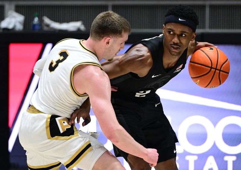 Mar 2, 2024; West Lafayette, Indiana, USA; Michigan State Spartans guard Tyson Walker (2) keeps the ball away from Purdue Boilermakers guard Braden Smith (3) during the second half at Mackey Arena. Mandatory Credit: Marc Lebryk-USA TODAY Sports