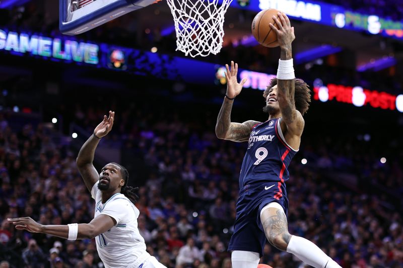 PHILADELPHIA, PENNSYLVANIA - DECEMBER 20: Kelly Oubre Jr. #9 of the Philadelphia 76ers shoots a lay up past Naz Reid #11 of the Minnesota Timberwolves during the second quarter  at the Wells Fargo Center on December 20, 2023 in Philadelphia, Pennsylvania. NOTE TO USER: User expressly acknowledges and agrees that, by downloading and or using this photograph, User is consenting to the terms and conditions of the Getty Images License Agreement. (Photo by Tim Nwachukwu/Getty Images)