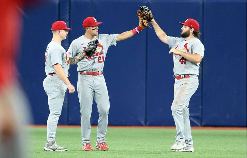 Aug 10, 2023; St. Petersburg, Florida, USA; St. Louis Cardinals left fielder Alec Burleson (41), center fielder Lars Nootbaar (21) and left fielder Tyler O'Neill (27) celebrate as they beat the Tampa Bay Rays at Tropicana Field. Mandatory Credit: Kim Klement Neitzel-USA TODAY Sports