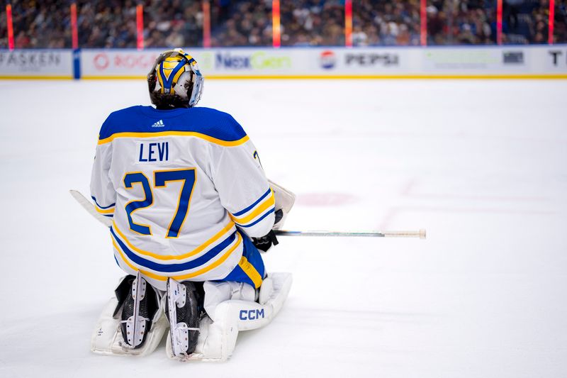 Mar 19, 2024; Vancouver, British Columbia, CAN; Buffalo Sabres goalie Devon Levi (27) rests during a stop in play against the Vancouver Canucks in the third period at Rogers Arena. Vancouver won 3 -2. Mandatory Credit: Bob Frid-USA TODAY Sports