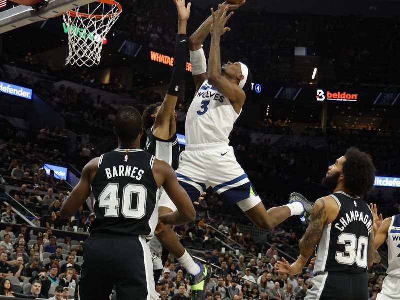 SAN ANTONIO, TX - NOVEMBER 2:  Jaden McDaniels of the Minnesota Timberwolves drives past San Antonio Spurs in the first half at Frost Bank Center on November 2, 2024 in San Antonio, Texas. NOTE TO USER: User expressly acknowledges and agrees that, by downloading and or using this photograph, User is consenting to terms and conditions of the Getty Images License Agreement. (Photo by Ronald Cortes/Getty Images)